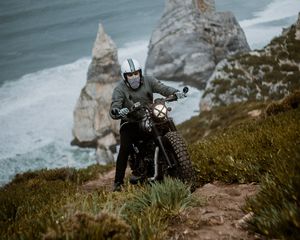 Preview wallpaper motorcyclist, motorcycle, helmet, rocks