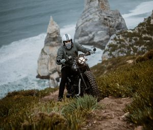 Preview wallpaper motorcyclist, motorcycle, helmet, rocks