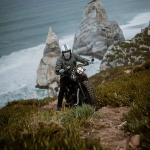 Preview wallpaper motorcyclist, motorcycle, helmet, rocks