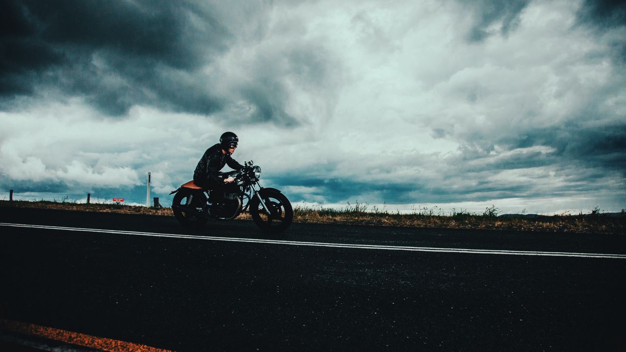 Wallpaper motorcyclist, road, marking, asphalt, helmet, clouds, overcast