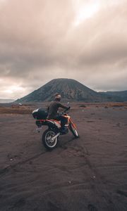 Preview wallpaper motorcyclist, sand, volcano, motorcycle, indonesia