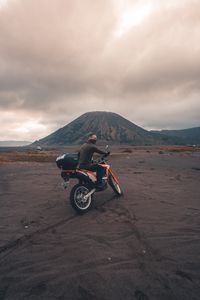 Preview wallpaper motorcyclist, sand, volcano, motorcycle, indonesia