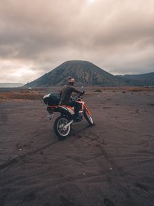 Preview wallpaper motorcyclist, sand, volcano, motorcycle, indonesia