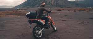 Preview wallpaper motorcyclist, sand, volcano, motorcycle, indonesia