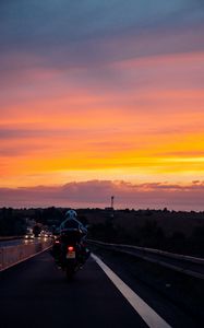 Preview wallpaper motorcyclist, sunset, sky, clouds, road, marking