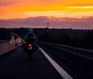 Preview wallpaper motorcyclist, sunset, sky, clouds, road, marking