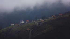 Preview wallpaper mountain, buildings, fog, cloud, aerial view, nature