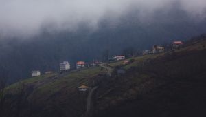 Preview wallpaper mountain, buildings, fog, cloud, aerial view, nature