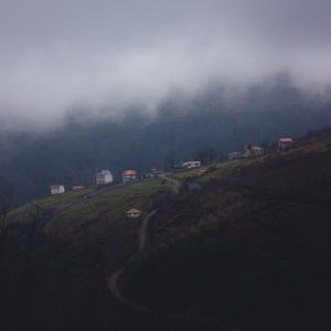 Preview wallpaper mountain, buildings, fog, cloud, aerial view, nature