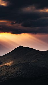 Preview wallpaper mountain, clouds, rays, light, dark