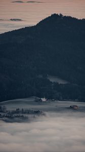 Preview wallpaper mountain, forest, fog, clouds, buildings, aerial view