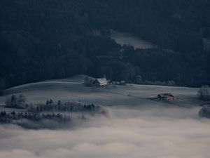 Preview wallpaper mountain, forest, fog, clouds, buildings, aerial view