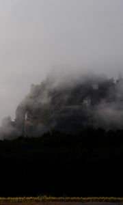 Preview wallpaper mountain, fortress, fog, forest, nature