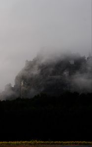 Preview wallpaper mountain, fortress, fog, forest, nature