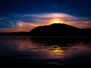 Preview wallpaper mountain, hill, silhouette, sea, sunset, dark