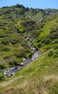 Preview wallpaper mountain, hill, stream, stones, grass, nature