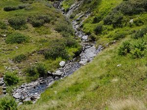 Preview wallpaper mountain, hill, stream, stones, grass, nature