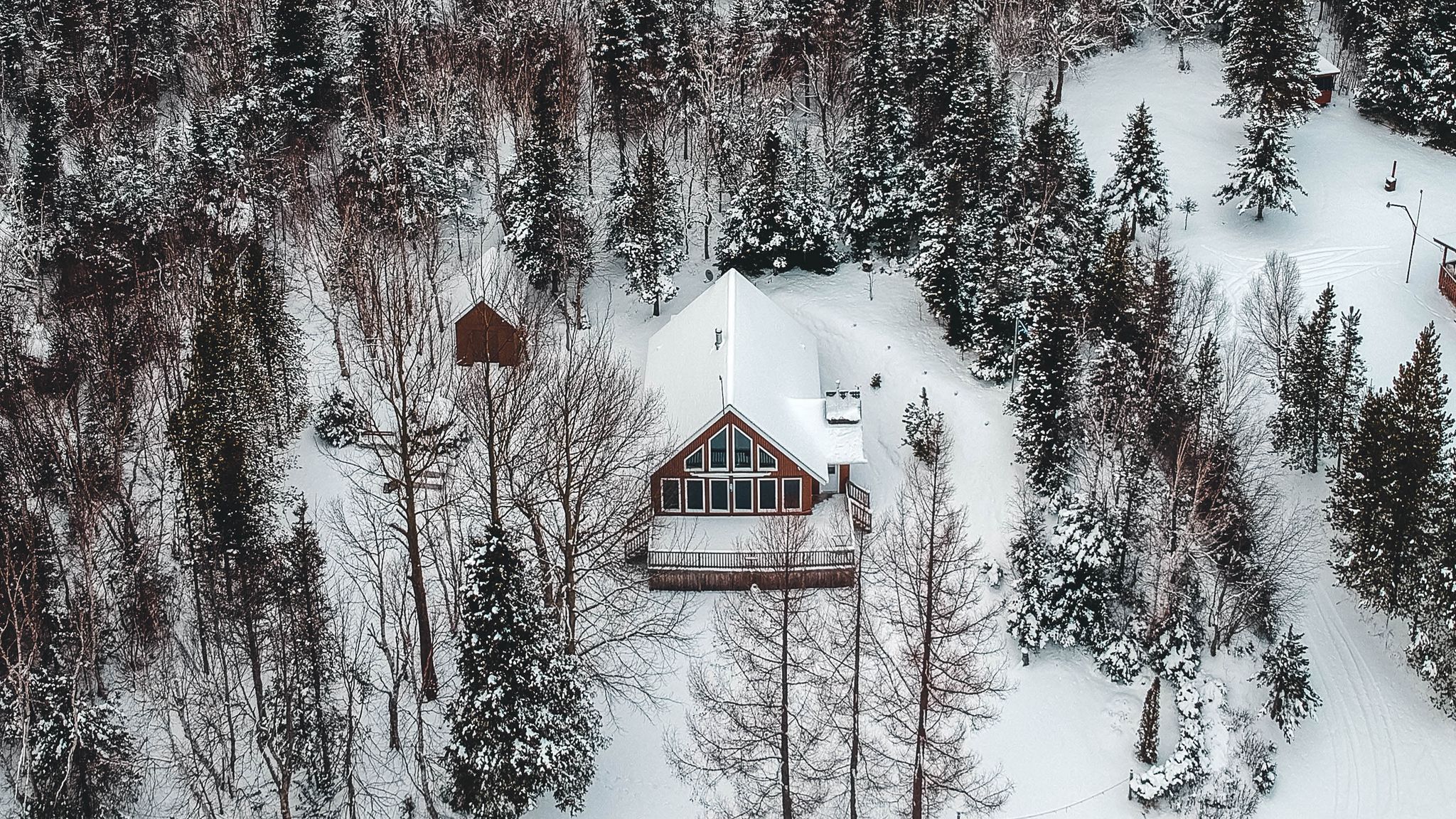 Download wallpaper 2048x1152 mountain, house, aerial view, trees, snow