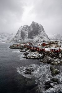Preview wallpaper mountain, houses, sea, waves, shore
