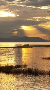 Preview wallpaper mountain, lake, boat, sunset, gold