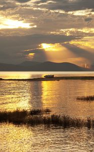 Preview wallpaper mountain, lake, boat, sunset, gold