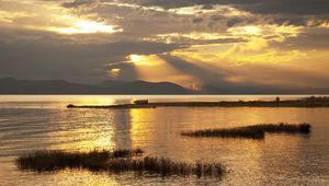 Preview wallpaper mountain, lake, boat, sunset, gold