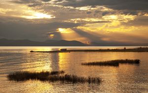 Preview wallpaper mountain, lake, boat, sunset, gold