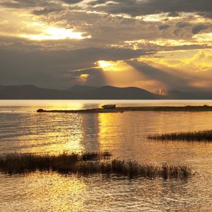 Preview wallpaper mountain, lake, boat, sunset, gold