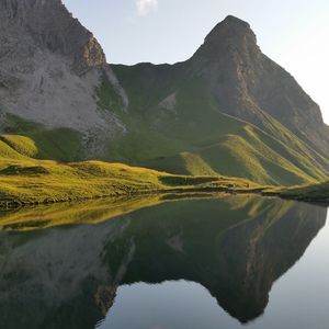 Preview wallpaper mountain, lake, grass, reflection