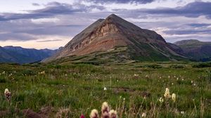 Preview wallpaper mountain, lawn, flowers, grass, landscape