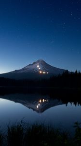 Preview wallpaper mountain, lights, lake, reflection, trees, night