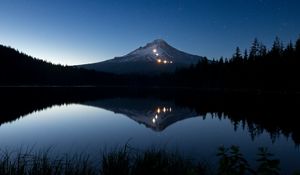 Preview wallpaper mountain, lights, lake, reflection, trees, night