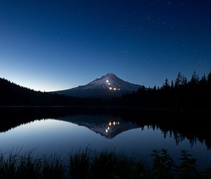 Preview wallpaper mountain, lights, lake, reflection, trees, night