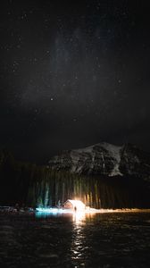 Preview wallpaper mountain, night, starry sky, silhouette, lake