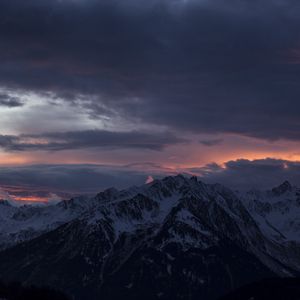 Preview wallpaper mountain, peak, clouds, snowy, sunset, night