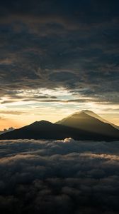 Preview wallpaper mountain, peak, clouds, dusk, light