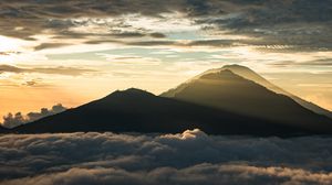 Preview wallpaper mountain, peak, clouds, dusk, light