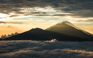 Preview wallpaper mountain, peak, clouds, dusk, light