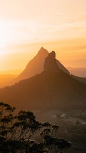 Preview wallpaper mountain, peak, fog, trees, sunset