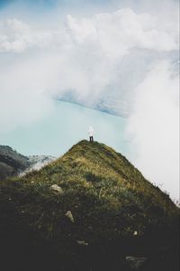 Preview wallpaper mountain, peak, loneliness, clouds, solitude, lonely, man