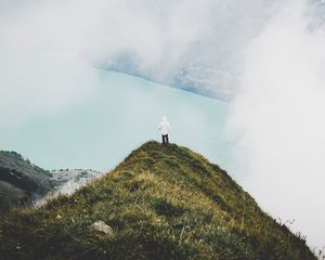 Preview wallpaper mountain, peak, loneliness, clouds, solitude, lonely, man