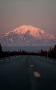 Preview wallpaper mountain, peak, road, forest, twilight