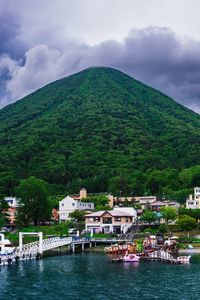 Preview wallpaper mountain, peak, sea, buildings, pier