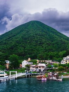 Preview wallpaper mountain, peak, sea, buildings, pier