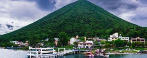 Preview wallpaper mountain, peak, sea, buildings, pier