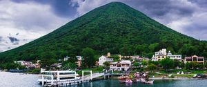 Preview wallpaper mountain, peak, sea, buildings, pier