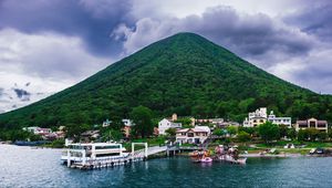 Preview wallpaper mountain, peak, sea, buildings, pier