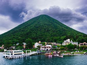 Preview wallpaper mountain, peak, sea, buildings, pier