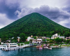 Preview wallpaper mountain, peak, sea, buildings, pier