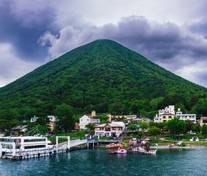 Preview wallpaper mountain, peak, sea, buildings, pier